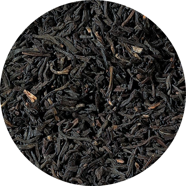 Close-up of black tea leaves on a white background