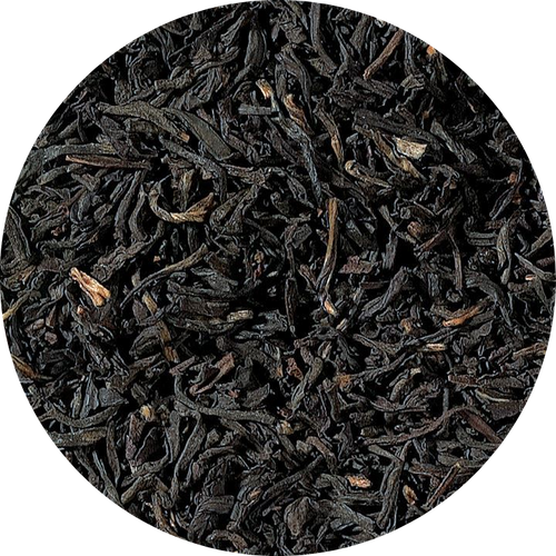 Close-up of black tea leaves on a white background