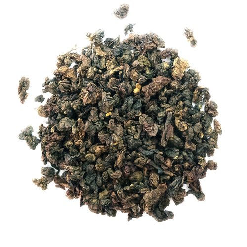 Brown rolled tea with golden tips on a white background