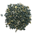 Dark green rolled tea on a white background